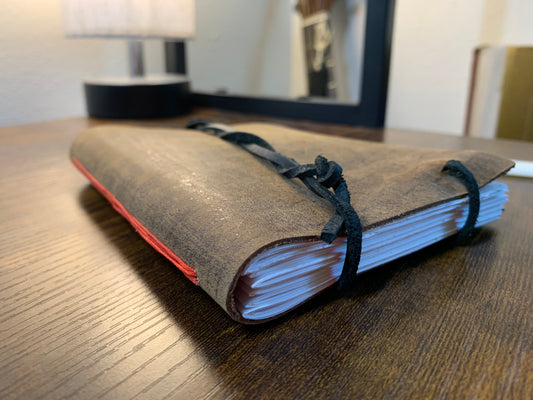 Simple Buffalo Leather travel journal red thread - Now on display at the Ferry County Food Co-op in Republic, WA!
